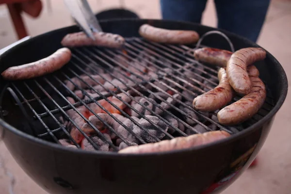 Cooking sausages on grill — Stock Photo, Image