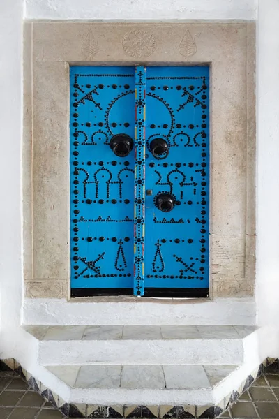 The ancient door is blue in Arabic style.