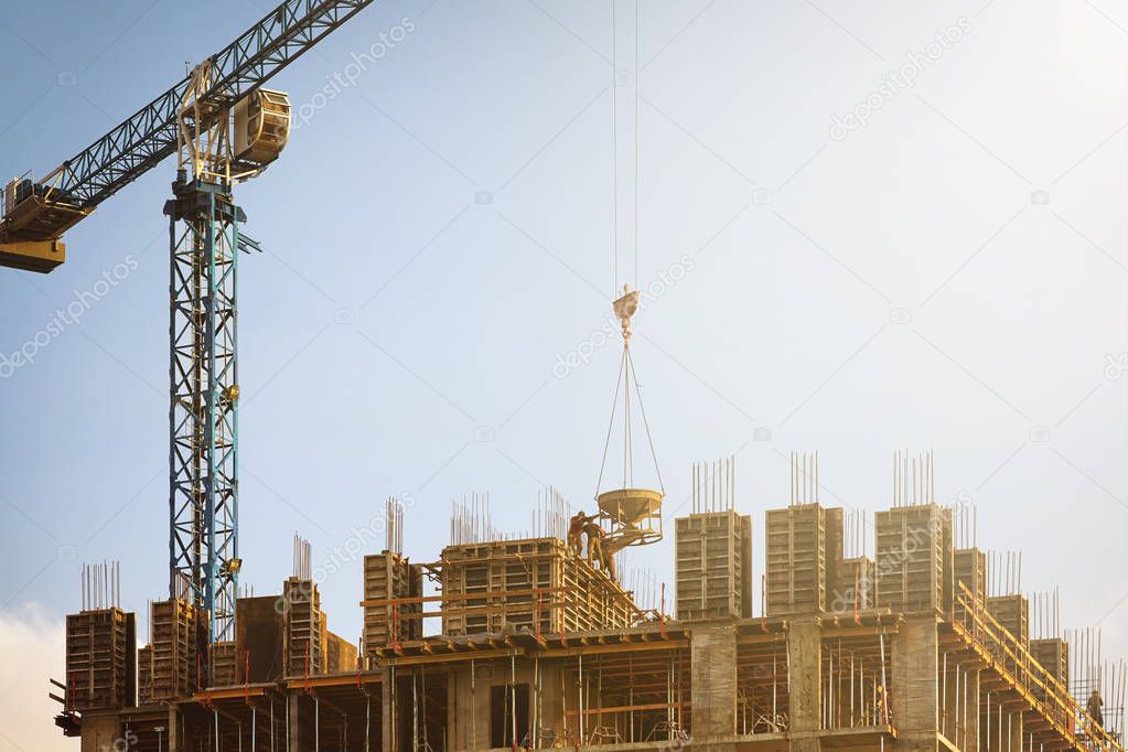 Building under construction with a working crane.