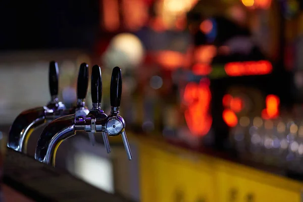 Bar counter with filling taps for beer and alcoholic beverages.