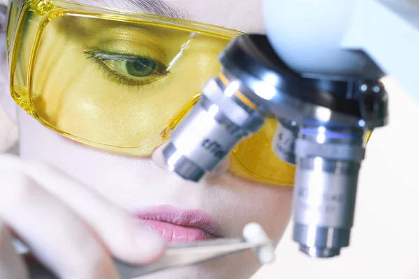 Крупним планом красива лабораторна дівчина в жовтому захисному окулярі — стокове фото