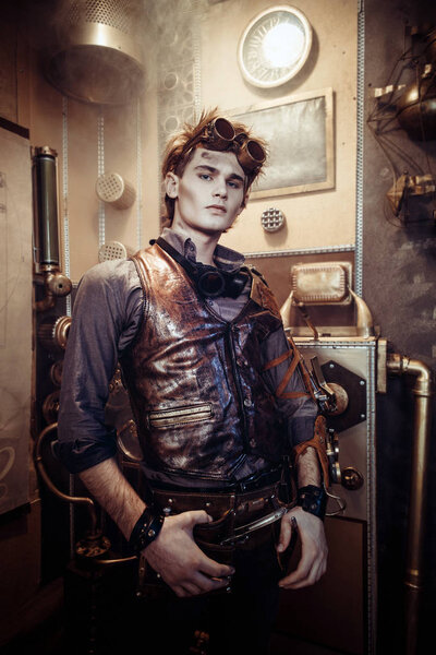 Portrait of a young steampunk man wearing glasses with mechanica