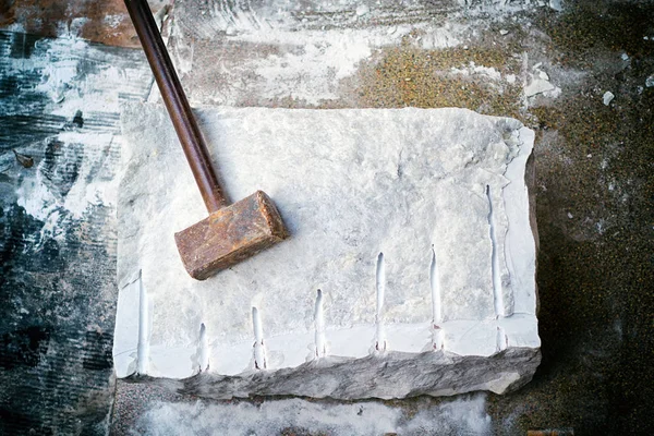 Primer plano de una gran pieza de mármol y un martillo después de dividir . — Foto de Stock