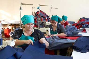 İş elbiseleri dikiş için fabrikada bir sahne. Üzerinde çalışmak