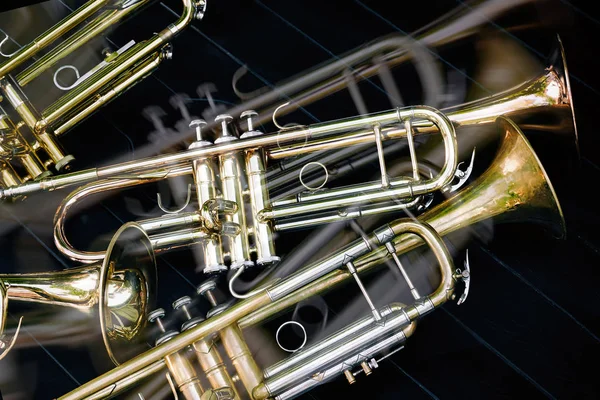 Several musical wind instruments orchestra golden trumpets.