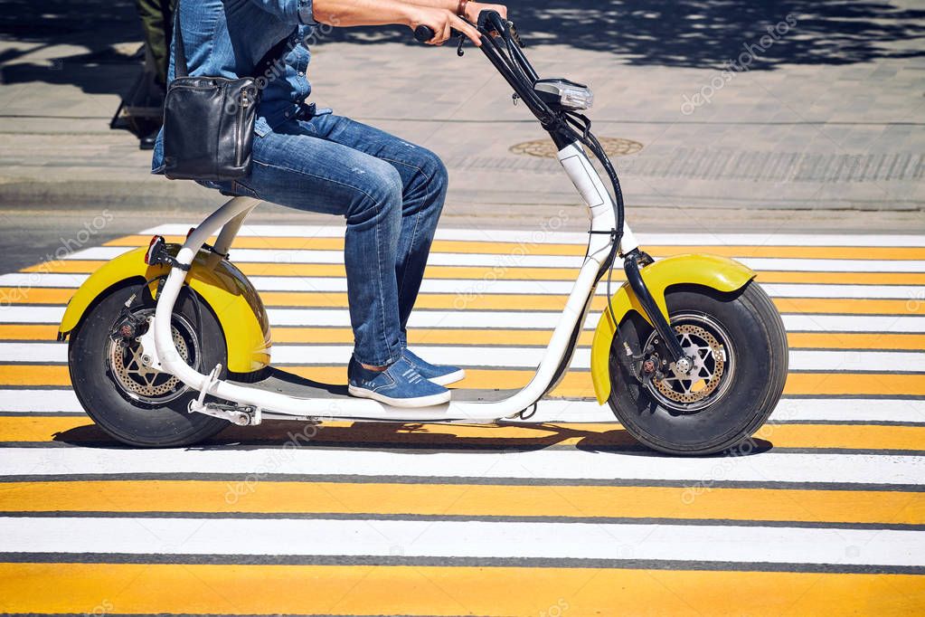 An electric motorcycle, scooter, or bicycle rides in the city. — Stock