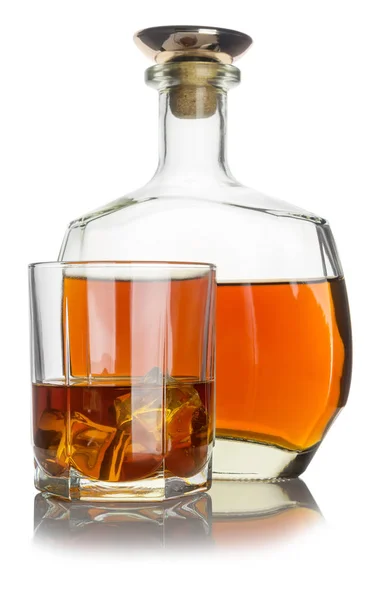 Glass with cognac and ice, next bottle with cognac — Stock Photo, Image