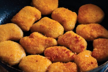 Tavuk külçeleri tereyağlı bir tavada kızartılır. Atıştırmalık.