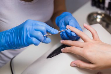 Manikürcü manikür için profesyonel makasla kütikül temizleyin