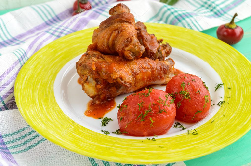 Chicken legs with tomato sauce and marinated tomatoes without skins in their own juice.