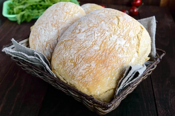 Ciabatta with cheese stuffing - freshly baked Italian white bread on a dark wooden background. For the preparation of sandwiches. — Stock Photo, Image