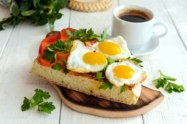 Брюскетта с перепелиным яйцом, перцем, травами и чашкой кофе. Легкий завтрак . — стоковое фото