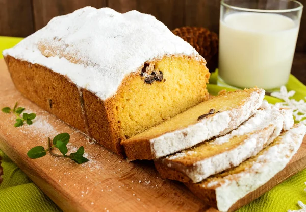 Свежеиспечённый домашний торт из буханки, украшающий верх сахарной пудрой на доске с молоком . — стоковое фото