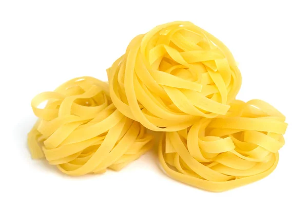 Pasta tagliatelle in a nest isolated on white background. Close-up. — Stock Photo, Image