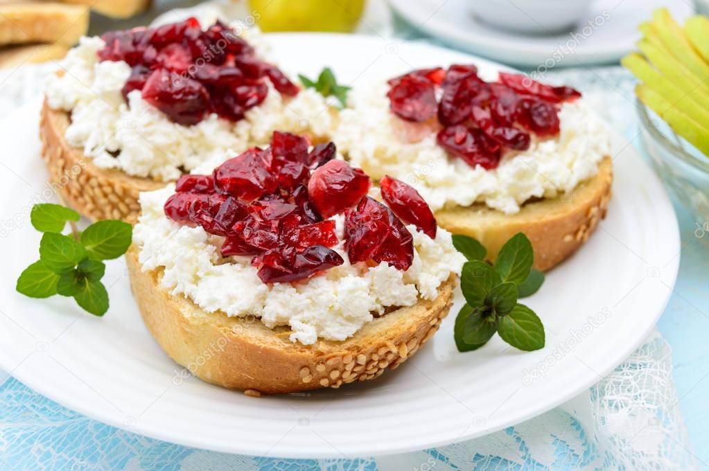 Delicious healthy breakfast: sandwiches with feta (cottage cheese), dried cranberries, pears, mint and a cup of coffee.