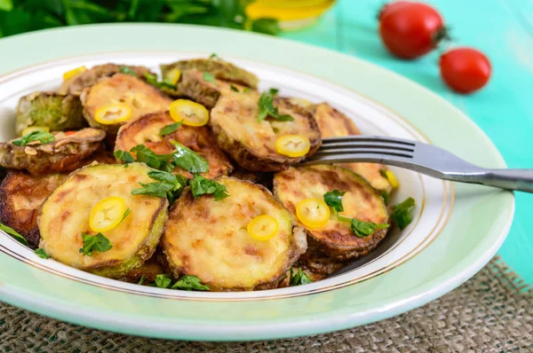 Fried slices of young zucchini with hot pepper, greens — Stock Photo, Image