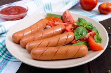 Domates ve fesleğen yaprakları ile sulu sosis 