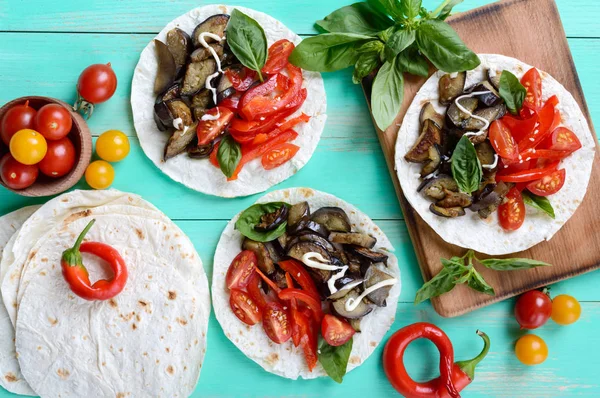 Vejetaryen tacos, cherry domates, patlıcanlı bir parlak ahşap arka plan üzerinde tatlı biber. Meksika yemek.