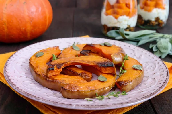 Pieces of pumpkin baked with herbs. — Free Stock Photo