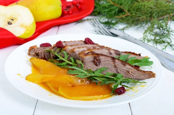 Goose breast Magret in berry sauce with caramelized pear, arugula on a white plate. — Stock Photo, Image