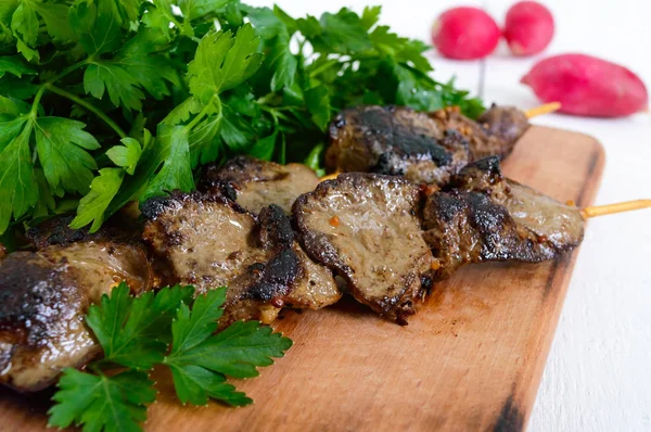 Rabbit liver roasted on skewers with herbs and radish. — Stock Photo, Image