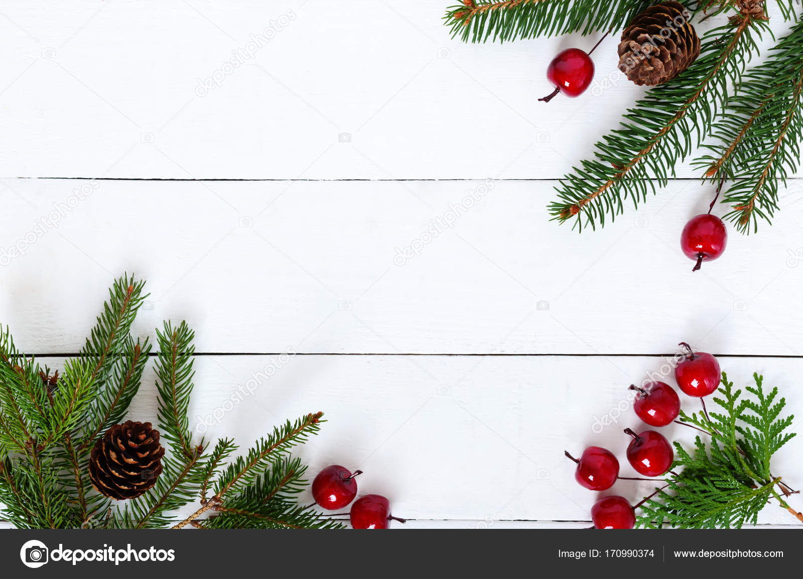 New Year's, Christmas theme. Green fir branches on white wooden background. Stock Photo by ©iaroshenko.marina.gmail.com 170990374
