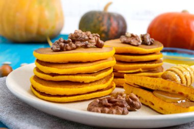 Bal ve mavi ahşap arka plan üzerinde ceviz ile güzel kokulu altın kabak krep. Geleneksel Amerikan yemeği