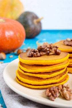 Bal ve mavi ahşap arka plan üzerinde ceviz ile güzel kokulu altın kabak krep. Geleneksel Amerikan yemeği