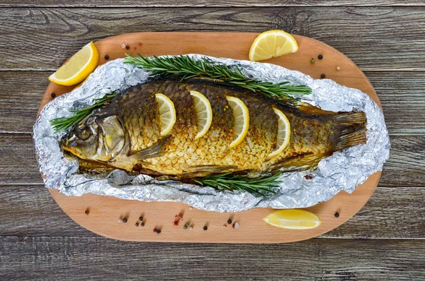 Large Baked Carp Herbs Lemon Spices Foil Wooden Background Top — Stock Photo, Image