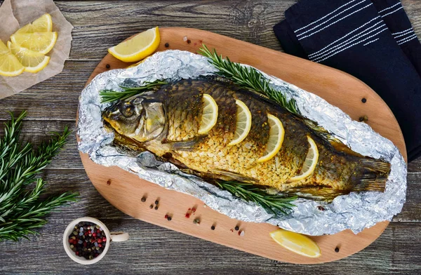 Large Baked Carp Herbs Lemon Spices Foil Wooden Background Top — Stock Photo, Image