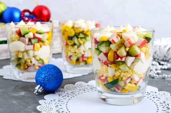 Crab salad. Delicious light salad of crab sticks, corn, fresh cucumbers, eggs in a glass cup. Holiday salad. Dishes for the New Year, Christmas.