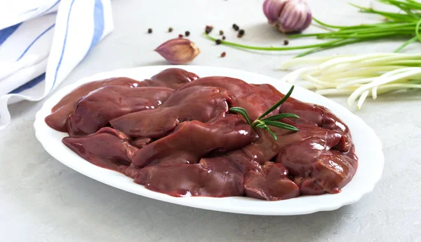 Raw chicken liver in a bowl on the table. Offal. Ready to cook. Top view. Dishes from the liver.