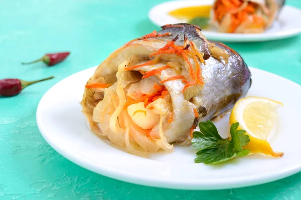 Baked herring stuffed with vegetables. Tasty fish rolls.