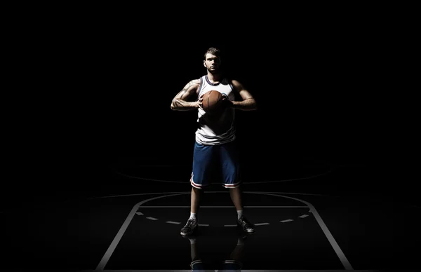 Young man basketball player with ball in studio isolated — Stock Photo, Image