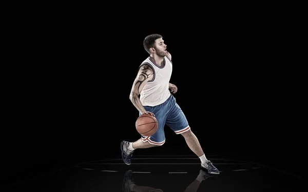 Siyah bir arka plan üzerinde izole topu ile beyaz basketbolcu