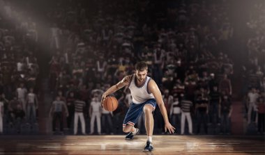 basketball player on court with ball in light rays clipart