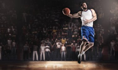 basketball player jumping with ball on stadium in lights clipart