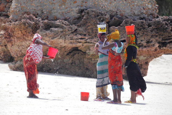 women on sandy beach