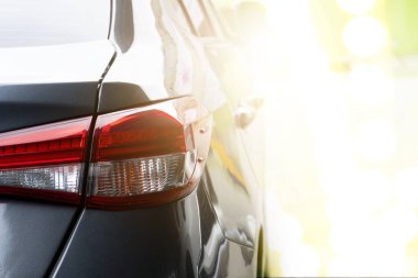 Park yerine park etmiş gri arabaların ışıkları gün batımında yanacak..