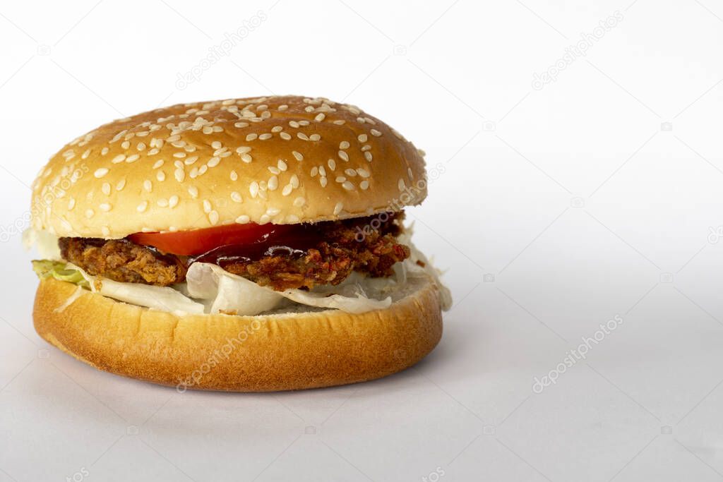 Homemade fried pork hamburger on a white background. No sauce.