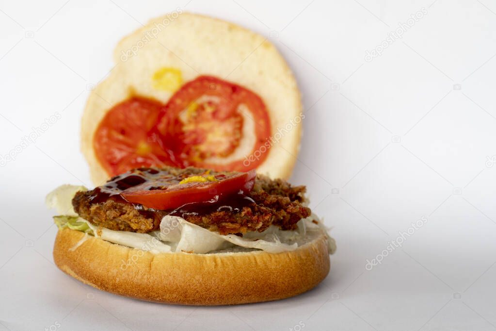 Homemade fried pork hamburger on a white background. Open the top slice of bread.