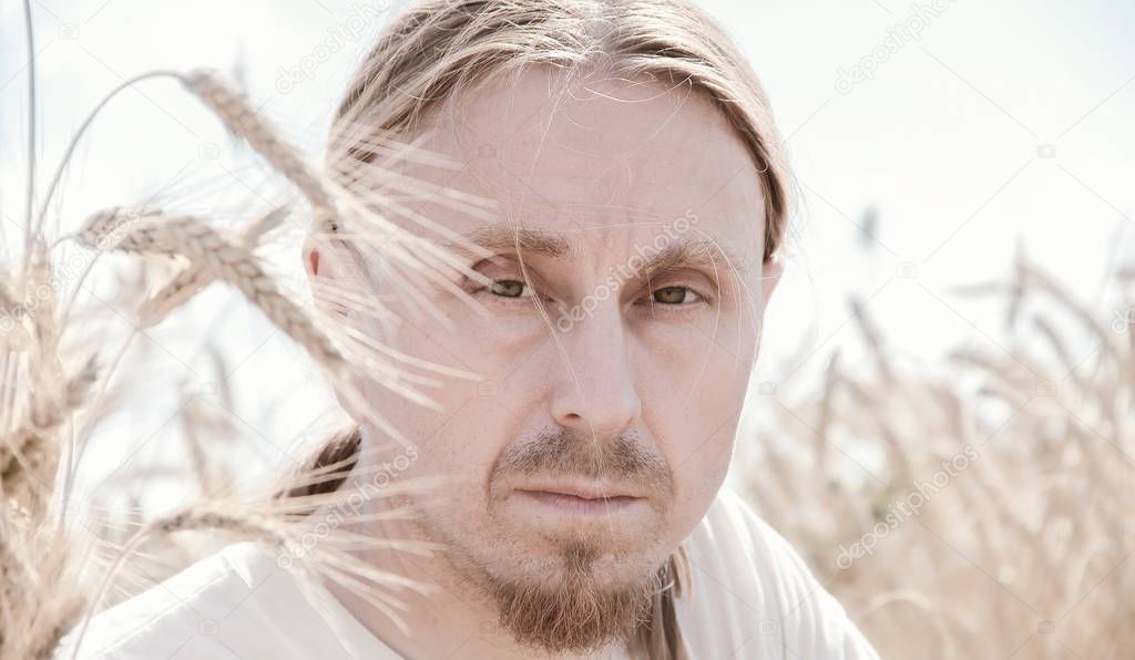 portrait of the Russian men peasant in the field wheat