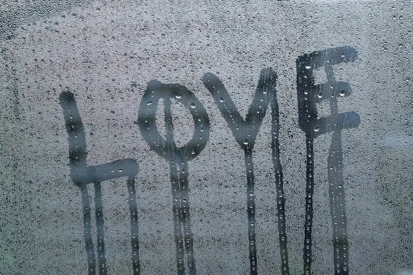 love words with water drops on the window