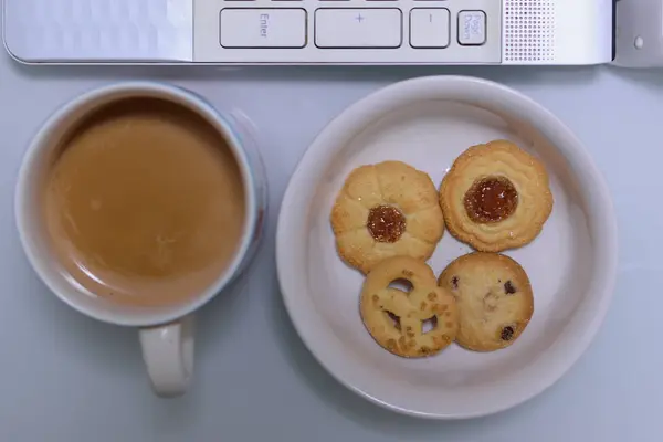 laptop with coffee and cookies