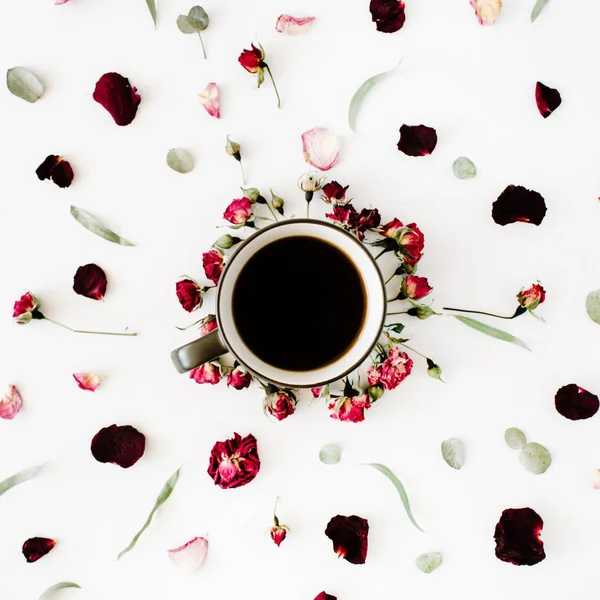 black coffee mug and red rose buds bouquet