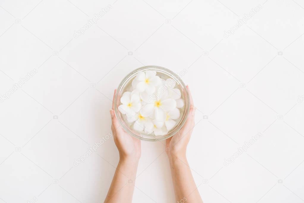 Exotic tropical palm flowers in girl's hands