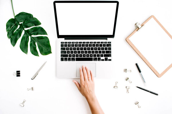 Workspace with woman working on laptop