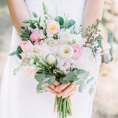 Beautiful wedding bouquet in bride's hands clipart