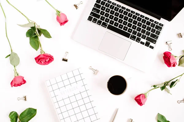 Werkruimte met rode rozen bloemen, koffiekopje, laptop, notebook — Stockfoto