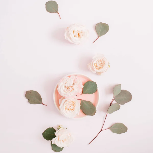 Beige roses and eucalyptus leaves